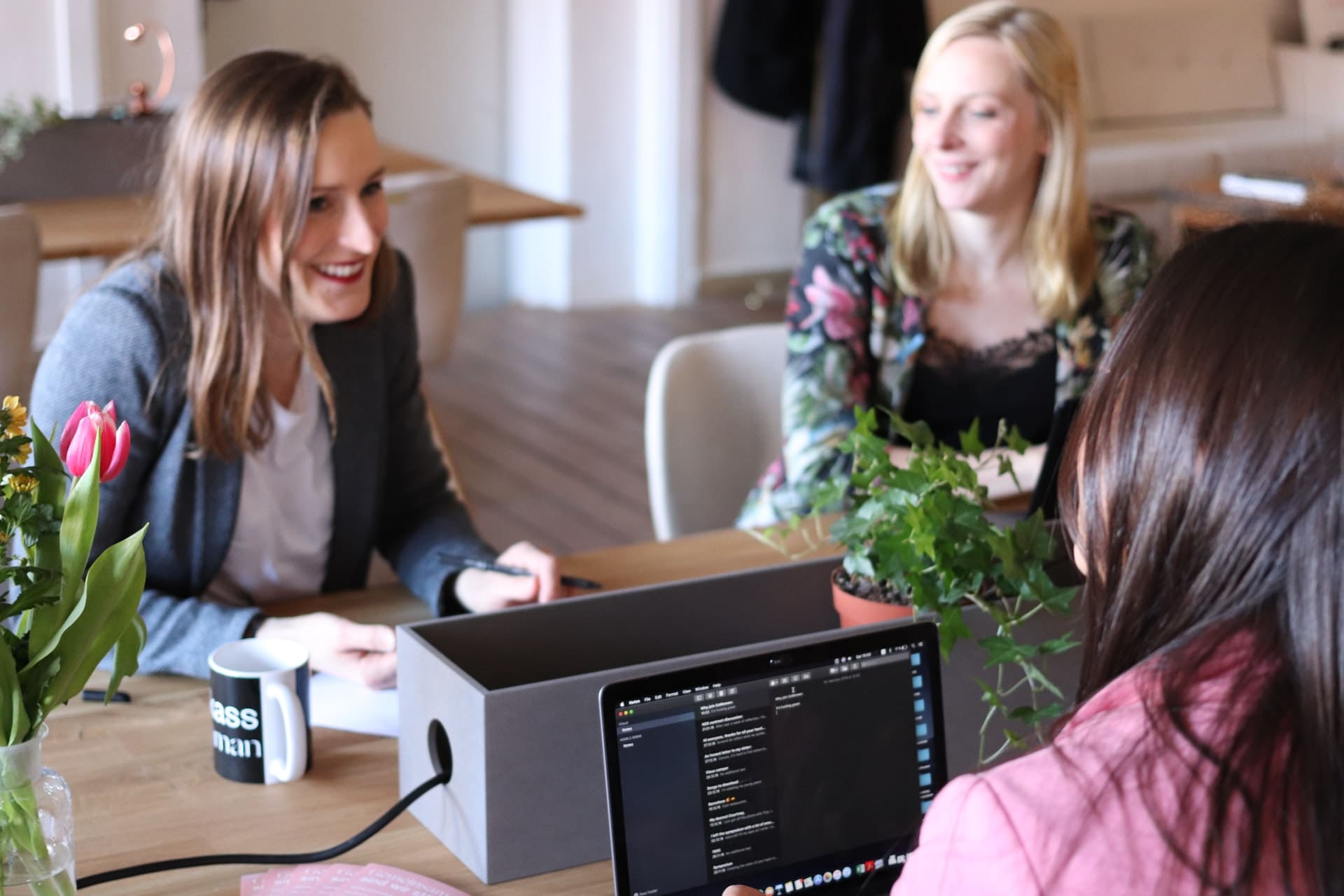 workplace mental health - picture of 3 women smiling at work